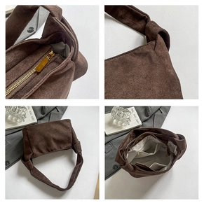 Détails du sac cabas en daim avec fermeture éclair, bandoulière nouée et poches