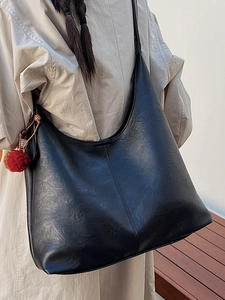 Large black faux leather hobo bucket bag with stylish red ball pendant for women