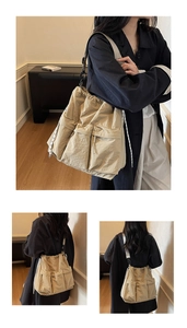 Detailed close-up of khaki tote bag with drawstring utility pockets and adjustable strap