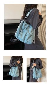 Close-up of light blue nylon crossbody bag featuring drawstring and wrinkled texture