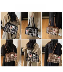Detail showing checkered canvas tote bags with leather straps and front zipper pocket