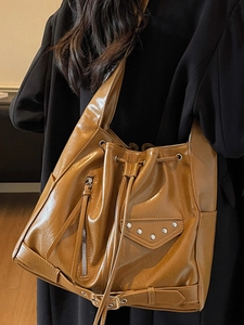 Retro tan large capacity bucket bag in glossy leather with drawstring and stud details