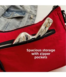 Detail of red nylon crossbody bag showing spacious inner storage and smooth metal zipper