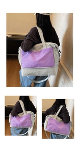 Detail of expandable nylon travel bag showing the side drawstring and purple plaid pocket