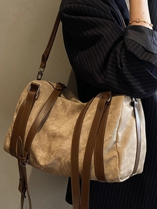 Vintage Boston pillow bag in khaki canvas with dark brown leather straps on model