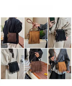 Détail du sac bohème avec rivets en étoile et pendentifs à pompons en trois couleurs