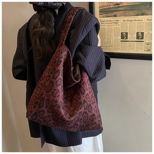 Macro shot of dark red leopard print tote bag in soft velvet with vintage style details