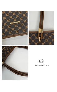 Detailed macro view of the brown leather tote bag texture and golden metal handle buckles