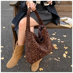 Leopard print canvas tote bag shown in an autumn outdoor setting with a large capacity