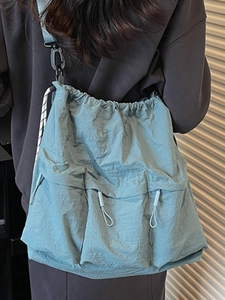 Light blue nylon crossbody bag with drawstring closure and large capacity multi-pockets