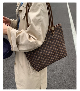 Macro detail of large coffee tote bag with geometric pattern and brown leather straps