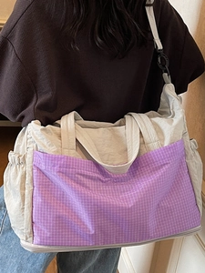 Chic nylon tote bag with purple checkered pockets and adjustable shoulder strap for travel