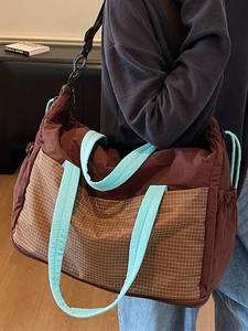 Fashionable color-block tote bag with brown pattern pocket and light blue straps