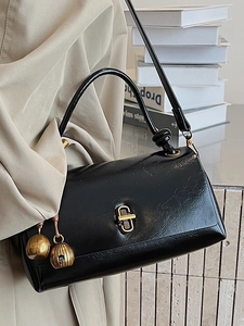 Vintage black faux leather crossbody bag with elegant gold hardware and spherical charms