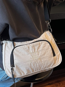 Vintage beige nylon crescent crossbody bag with black trim and embroidery on shoulder