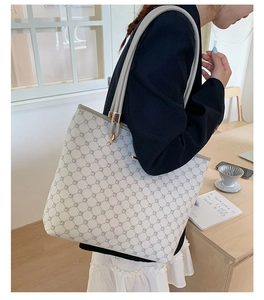 Minimalist tote bag with geometric pattern on cream leather shown in casual indoor setting