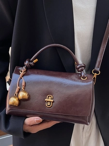 Retro dark brown leather crossbody bag with vintage metal lock and woven handle detail