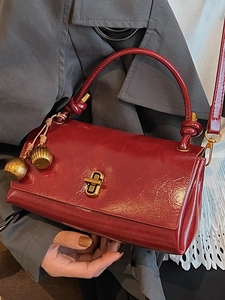 Vintage dark red glossy leather crossbody bag with woven handle and gold accents