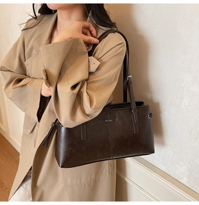 Detail of vintage brown leopard style handbag showing side drawstrings and metallic branding