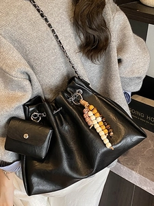 Black leather bucket bag with silver chain strap and colorful bead charm detail