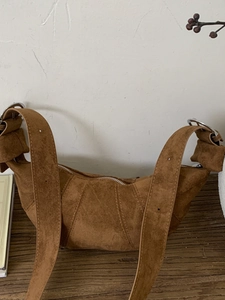 Brown suede croissant shoulder bag with adjustable strap and vintage silver hardware