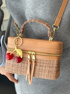 Brown leather and tweed box handbag with gold hardware and a cherry bag charm
