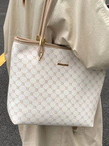 Minimalist beige tote bag with brown geometric patterns and leather straps for commuting