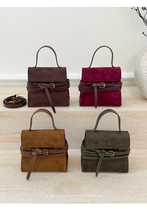 Minimalist retro tote bags in suede textures with gold metal buckles on marble stairs