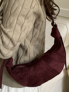 Burgundy matte leather croissant shoulder bag with stitched segments for autumn style