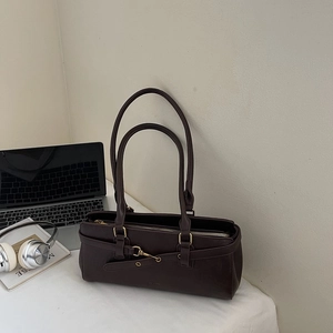 Detail view of the vintage dark brown leather shoulder bag with metallic hook buckle closure