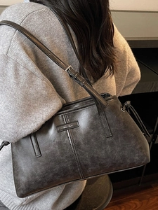 Retro charcoal grey leather shoulder bag with adjustable straps and matte texture