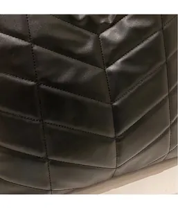 Close-up of black V-shaped quilted leather texture on casual lightweight tote bag