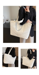 Detail of white quilted tote bag with V-pattern stitching and large interior capacity