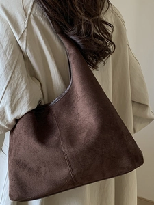 Minimalist large dark brown suede tote bag for women shown from a stylish side view angle