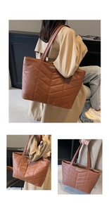 Detail of dark brown quilted leather tote bag with elegant V-stitching and brand logo