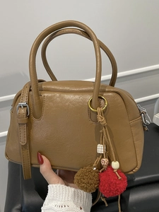 Retro brown Boston handbag with textured leather and decorative plush charm