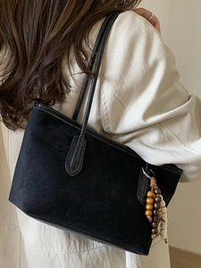 Minimalist black matte tote bag for women with wooden bead pendant and long shoulder strap