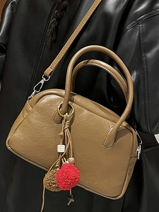 Brown lychee leather Boston bag with vintage charms and silver hardware for women