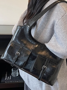 Minimalist black glossy leather tote bag with dual front pockets for office and daily wear