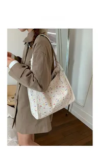 Floral shoulder tote bag shown in a lifestyle setting with adjustable straps and print