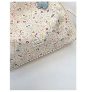 Close-up of floral tote bag with high-quality fabric texture and Aimater leather brand logo