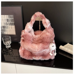 Detail view of the soft pink faux fur tote bag texture with a cute plush charm accessory
