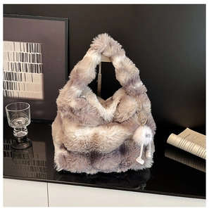 Detailed texture of marble-patterned faux fur handbag with a cute white plush pendant
