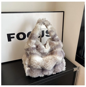 Close-up of winter faux fur handbag featuring soft grey and white mottled texture detail