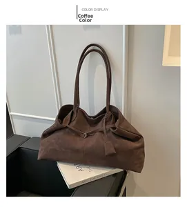 Detail view of the coffee suede tote bag showing soft texture and elegant strap design
