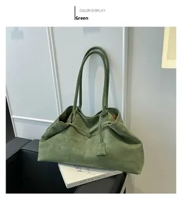 Detailed texture of green suede tote bag with drawstring detail and matching pendant