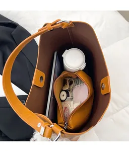 Top view of spacious brown leather bucket bag showing large interior capacity and storage