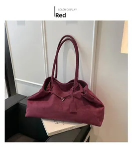 Detail view of large burgundy velvet tote bag with matte texture and metal ring buckle