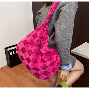 Close-up detail of the pink checkered plush tote bag texture with zipper closure