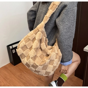 Detailed texture of a large capacity checkered plush hobo bag for autumn winter fashion
